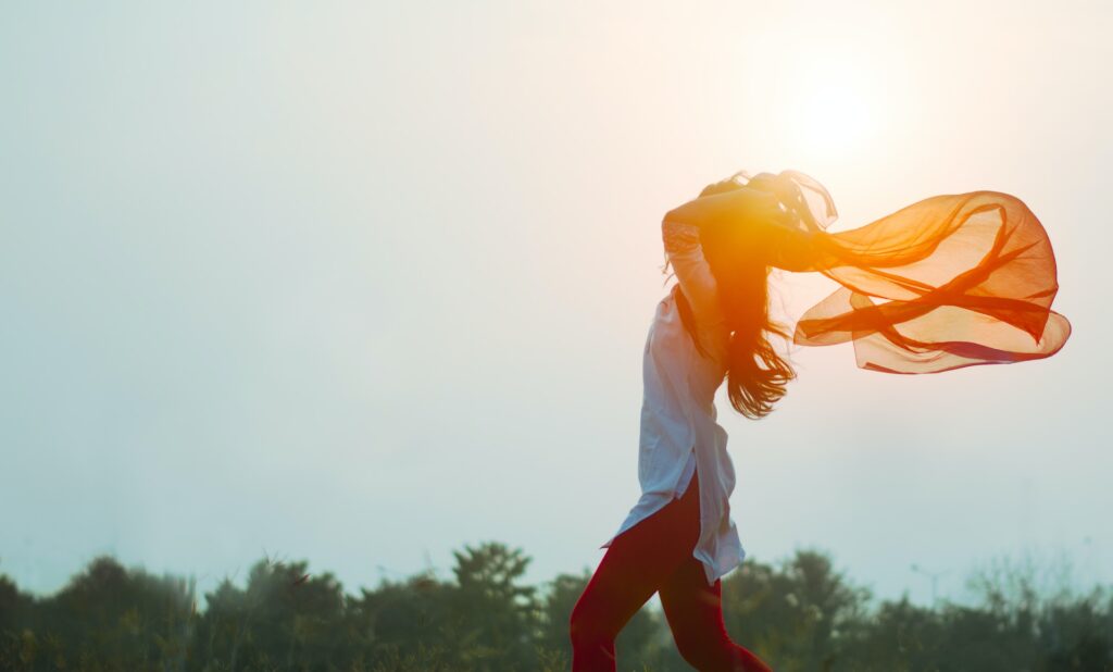 woman filled with joy holding a scarf